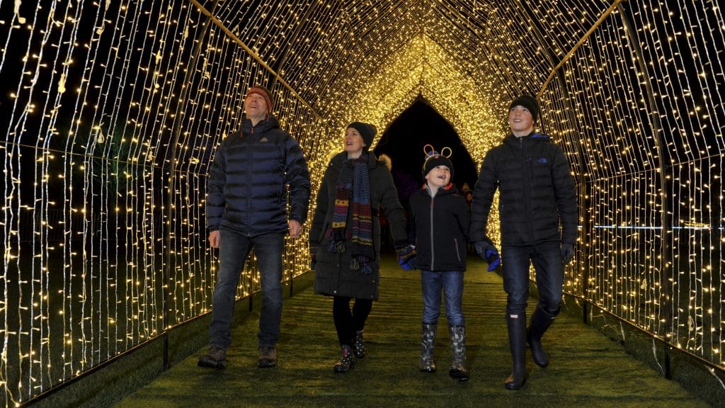 A family enjoying the Christmas light experience at Winter Glow.