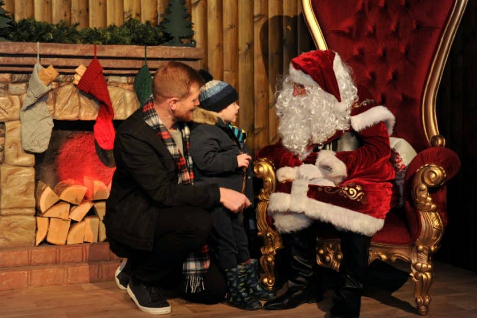 A father and son meeting with Santa at Winter Glow